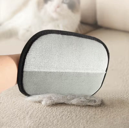 Pet hair remover mitt lifting cat fur off a sofa